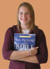 Person holding Big Picture of the Bible book